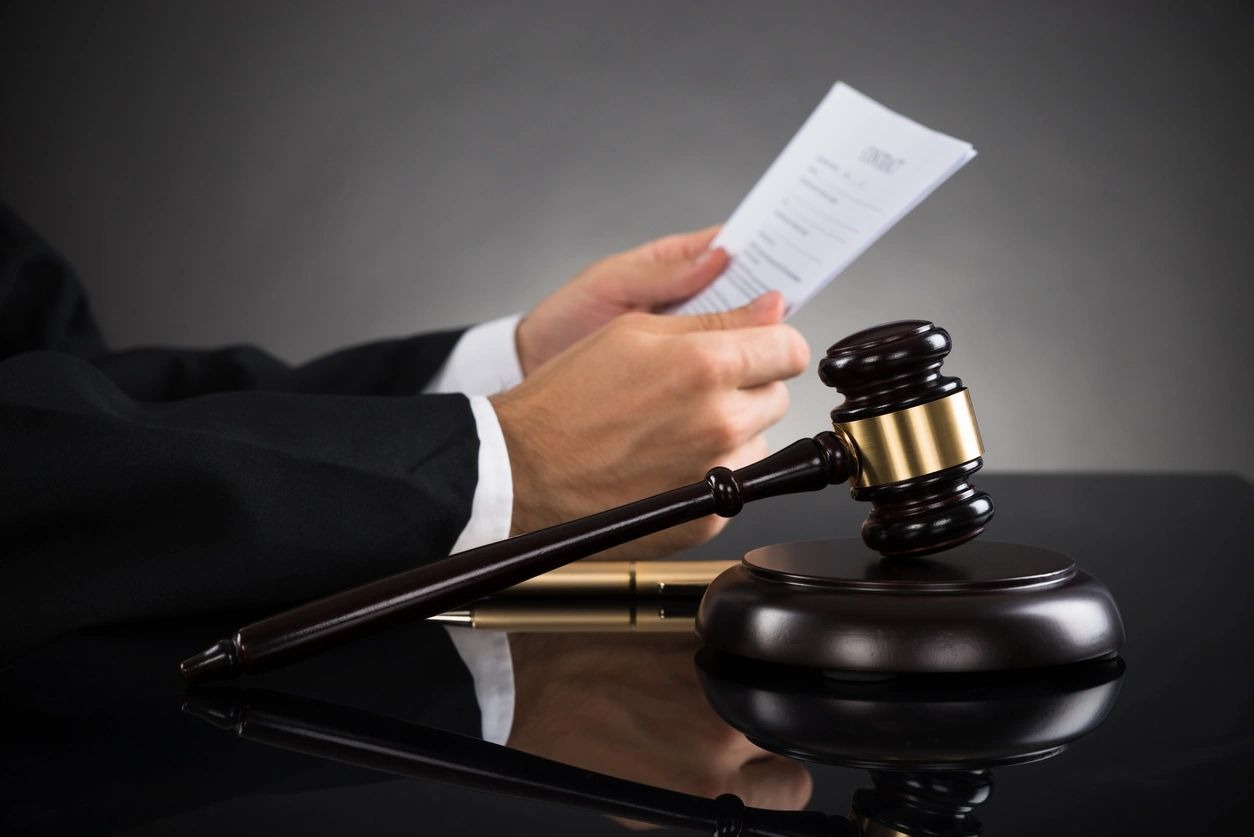 Judge Holding Document At Desk